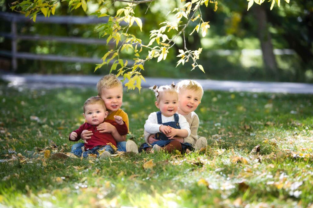 toddlers sitting on the grass