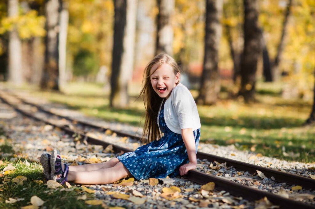 girl sitting on railway